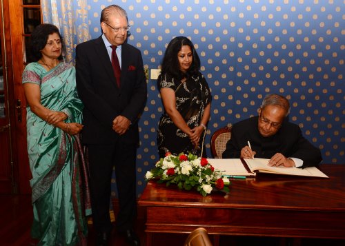 The President of India, Shri Pranab Mukherjee signing the Visitors' Book at the State House, Le Réduit in Port Louis, Mauritius on March 11, 2013. The President of the Republic of Mauritius, H.E. Mr. Rajkeswur Purryag GCSK, GOSK and Mrs. Aneetah Purryag