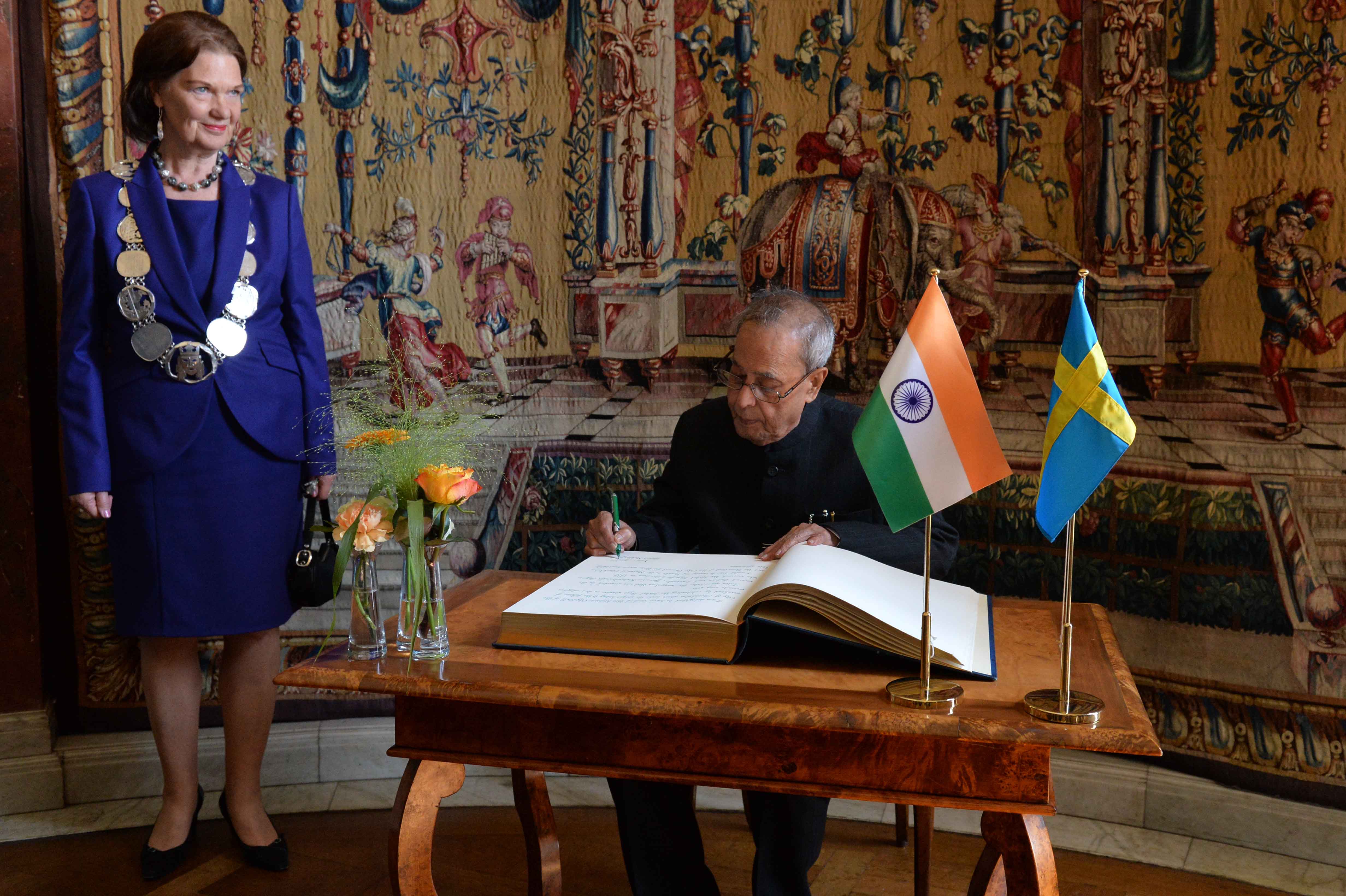 The President, Shri Pranab Mukherjee signing the visitor’s book at Stockholm in Sweden on June 1, 2015. The Mayor of Stockholm, Ms. Karin Wanngard is also seen.