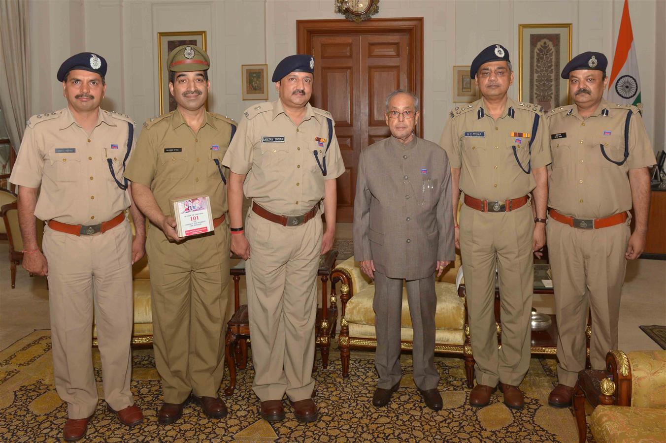 Shri G.C. Mishra Director along with other officers from Delhi Fire Service pinning flag on the President of India, Shri Pranab Mukherjee on the occasion of Fire Service Week at Rashtrapati Bhavan on April 14, 2016. 