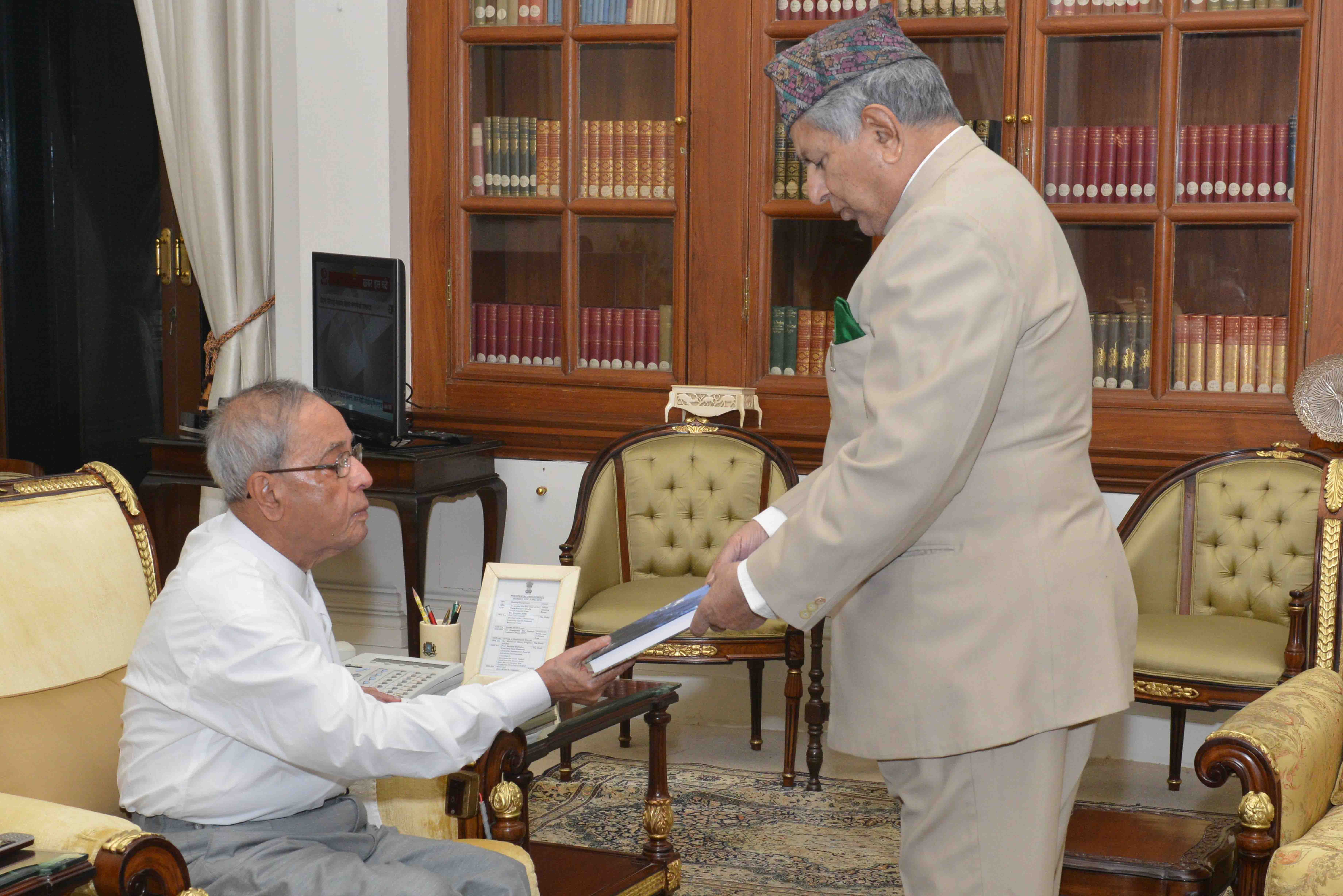 The President of India, Shri Pranab Mukherjee receiving the book 'India's North-East and Asiatic South-East: Beyond Borders' and 'Uzbekistan Threshold of an Era' from Prof. Rashpal Malhotra at Rashtrapati Bhavan on June 08, 2015.