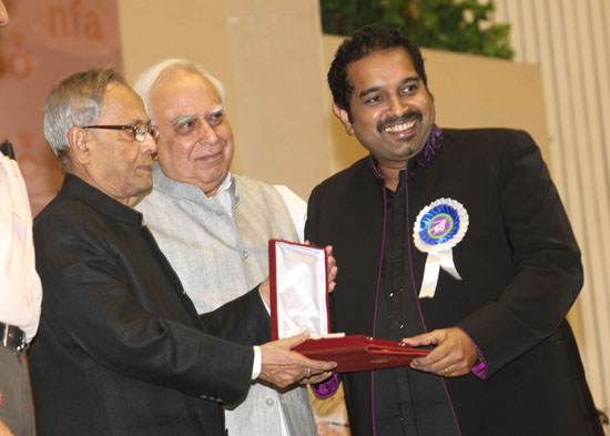 The President of India, Shri Pranab Mukherjee presenting the Best Male playback singer Award to Shri Shankar Mahadevan at the 60th National Film Awards Function at Vigyan Bhavan in New Delhi on May 3, 2013. Also seen is the Union Minister of Communicatio