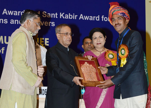 The President of India, Shri Pranab Mukherjee while presenting a National Award, Shilp Guru Awards and Sant Kabir Awards to weavers and artisans for the year 2011 at Vigyan Bhavan in New Delhi on July 1, 2014. Also seen is the Union Minister of State for 