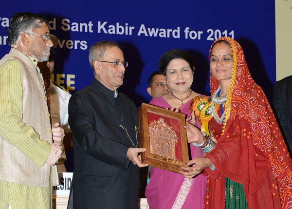 The President of India, Shri Pranab Mukherjee while presenting a National Award, Shilp Guru Awards and Sant Kabir Awards to weavers and artisans for the year 2011 at Vigyan Bhavan in New Delhi on July 1, 2014. Also seen is the Union Minister of State for 