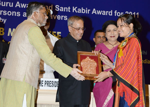 The President of India, Shri Pranab Mukherjee while presenting a National Award, Shilp Guru Awards and Sant Kabir Awards to weavers and artisans for the year 2011 at Vigyan Bhavan in New Delhi on July 1, 2014. Also seen is the Union Minister of State for 