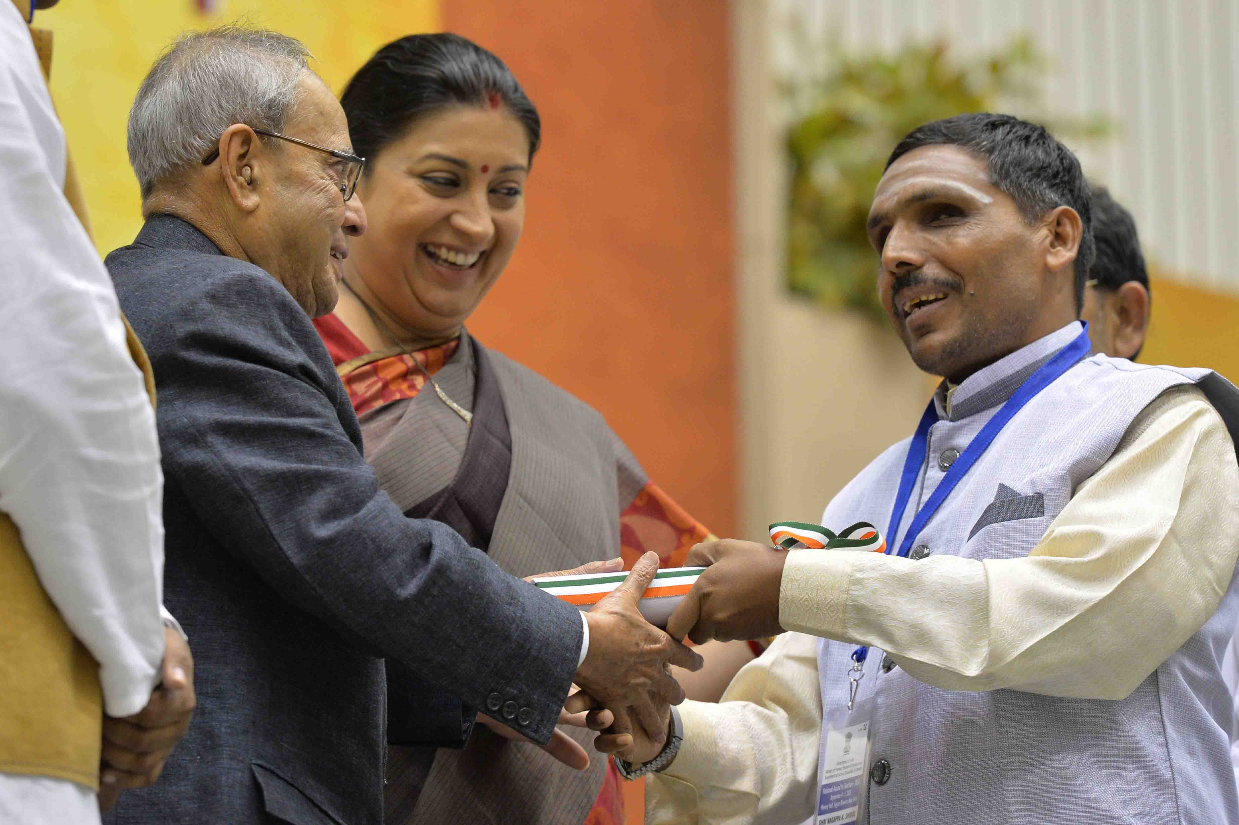 The President of India, Shri Pranab Mukherjee presenting a National Award to teacher on the occasion of Teachers’ Day at Vigyan Bhavan in New Delhi on September 5, 2015.