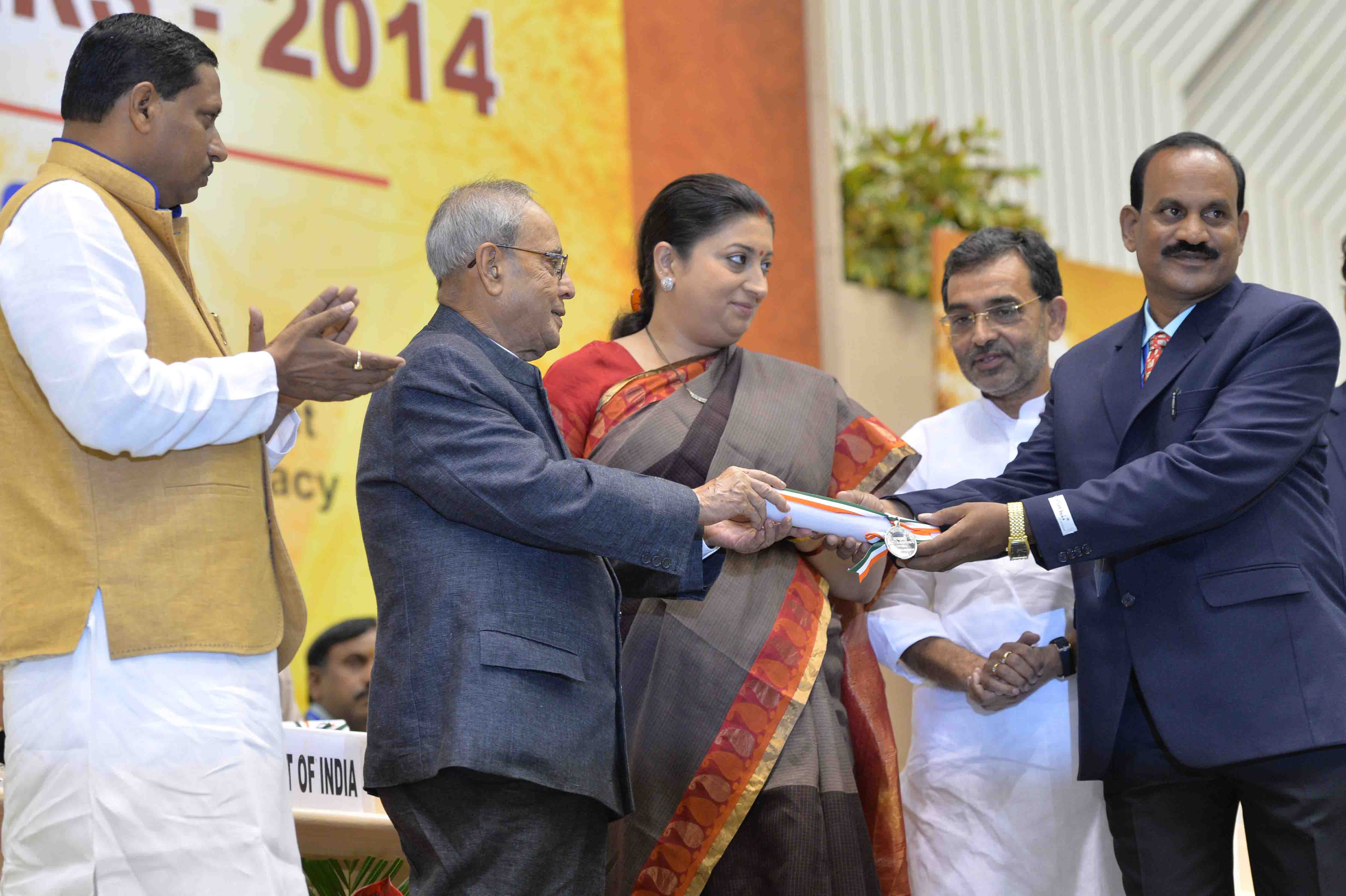 The President of India, Shri Pranab Mukherjee presenting a National Award to teacher on the occasion of Teachers’ Day at Vigyan Bhavan in New Delhi on September 5, 2015.