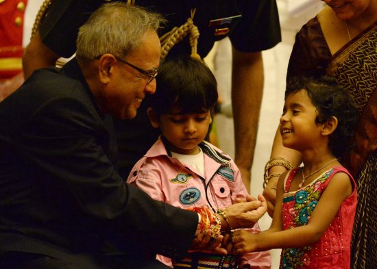 The President of India, Shri Pranab Mukherjee being tied a Rakhi by a child at Rashtrapati Bhavan on August 20, 2013 on the occasion of Raksha Bandhan.