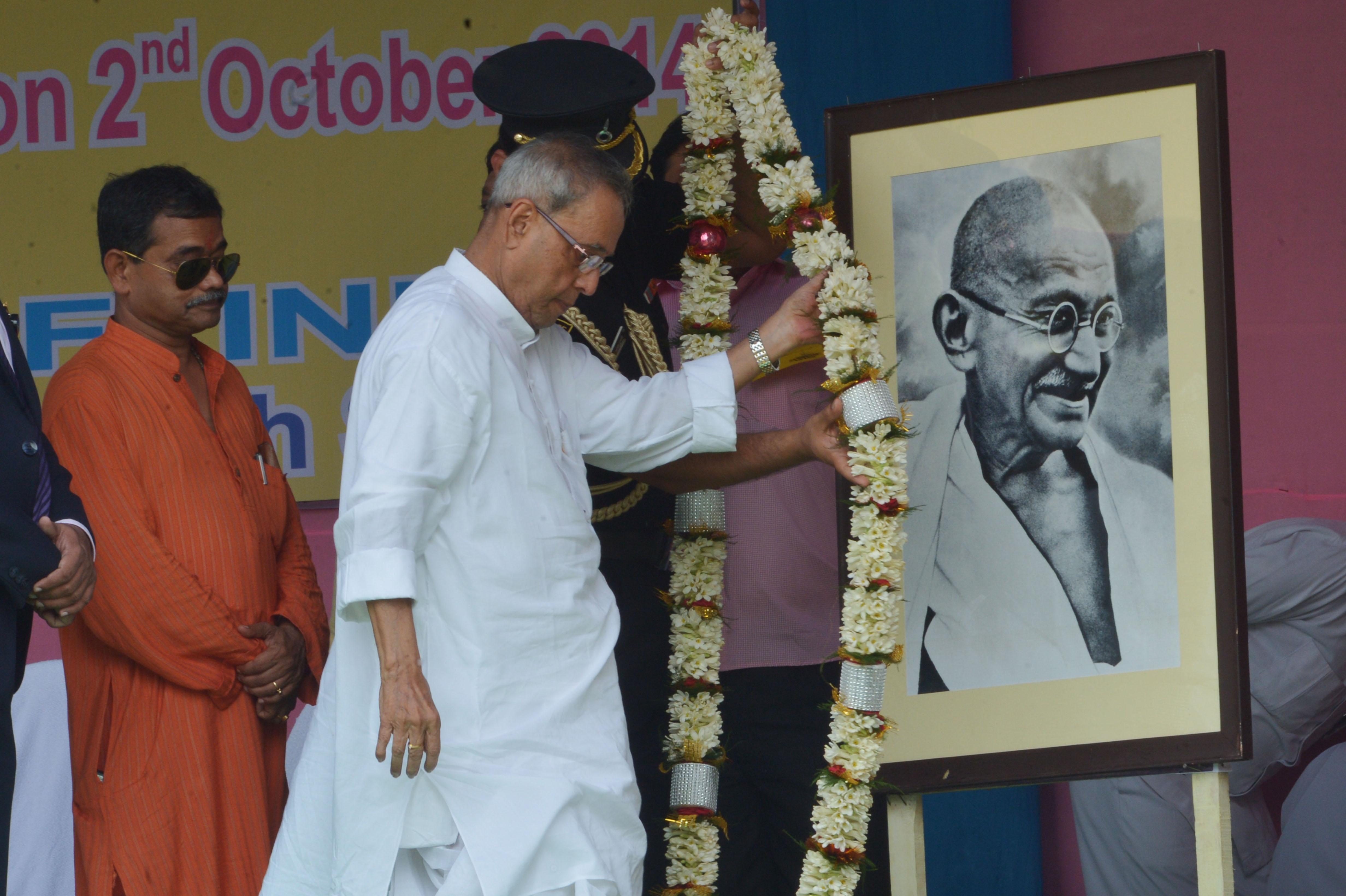 The President of India, Shri Pranab Mukherjee paying floral tributes at the portrait of Mahatma Gandhi at Kirnahar Shib Chandra High School at Kirnahar, District Birbhum in West Bengal on October 2, 2014 on the occasion of Gandhi Jayanti. 