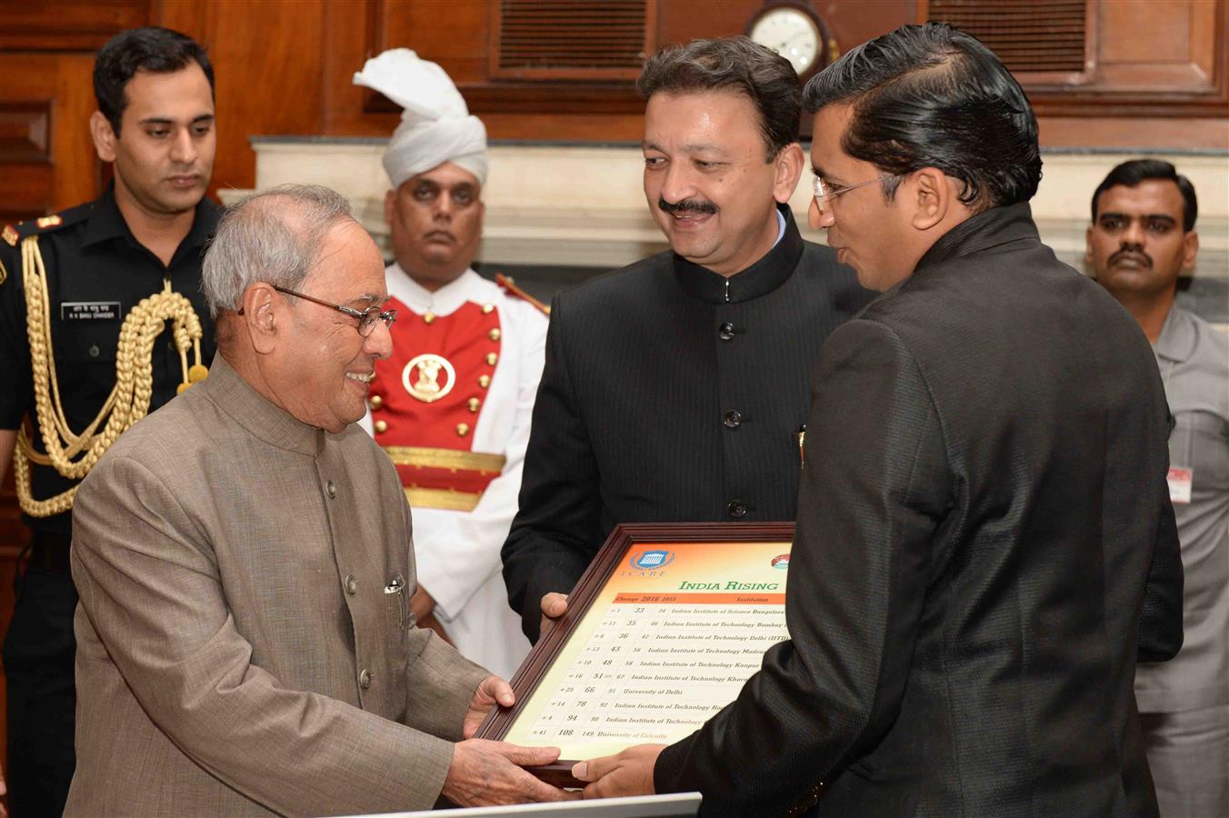 The President of India, Shri Pranab Mukherjee receiving the "State of Indian Universities in the Global Academic Rankings" (India Rising) from Dr Karthick Sridhar and Prof.(Dr) Sanjay Deshmukh, Vice Chancellor, University of Mumbai at Rashtrapati Bhavan 