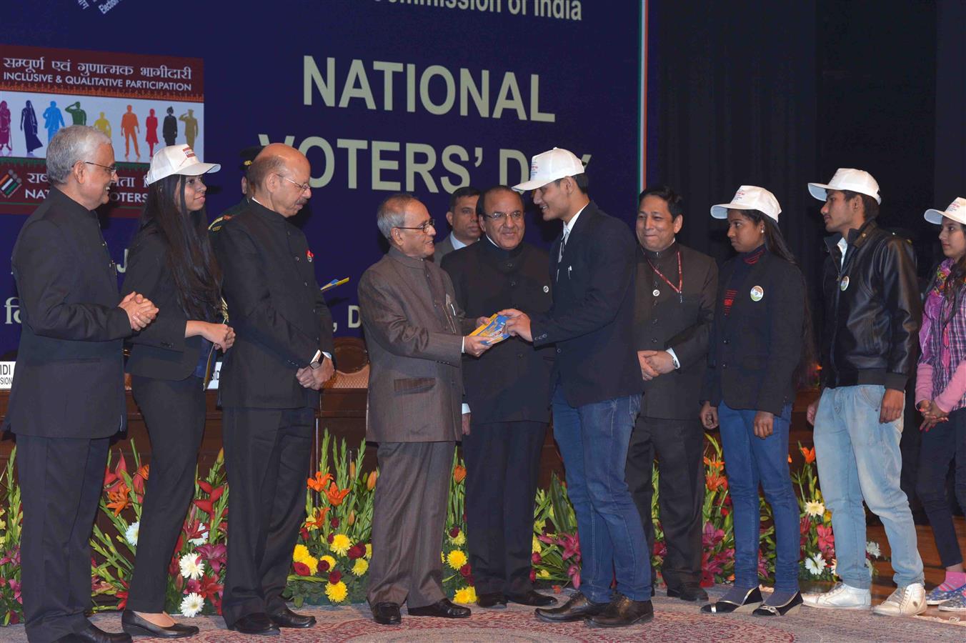 The President of India, Shri Pranab Mukherjee presenting the Election Photo Identify Cards [EPICs] to newly registered young voter at the 6th National Voters' Day Celebration organized by the Election Commission of India in New Delhi on January 25, 2016. 