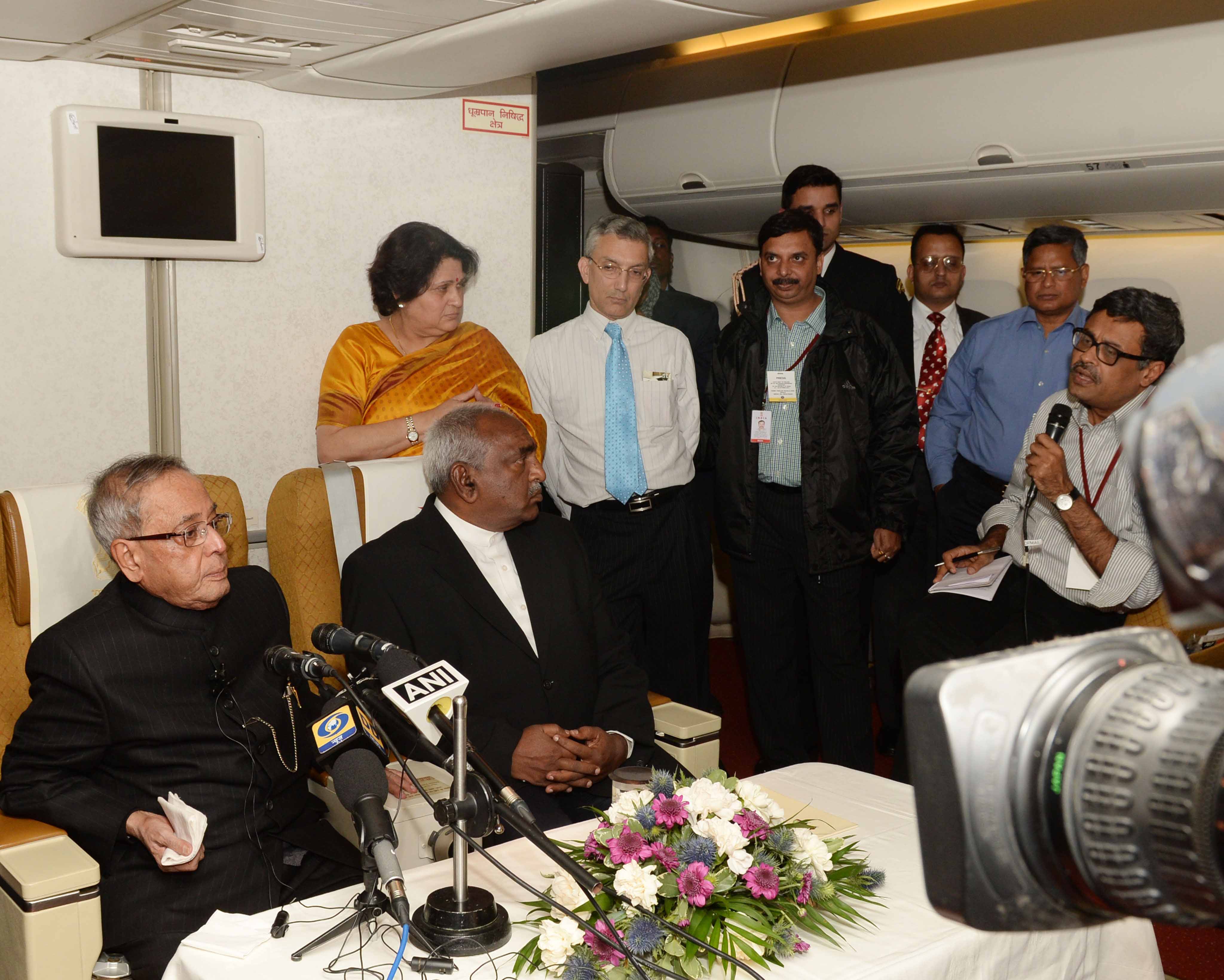 The President of India, Shri Pranab Mukherjee interacting with his accompanying media Personnel on board the special aircraft on October 17, 2014 on his way back to India from 