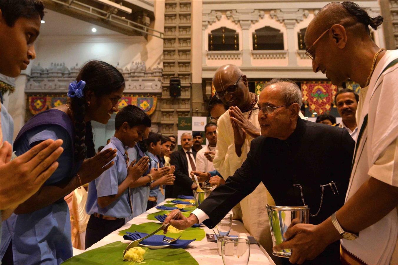 The President of India, Shri Pranab Mukherjee serving of meals to few children during the visit to ISKCON-Temple at Bangalore in Karnataka on August 27, 2016. 