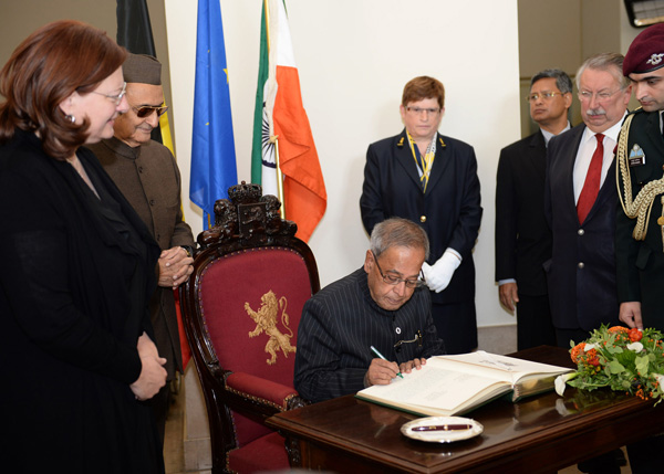 The President of India, Shri Pranab Mukherjee signing the Visitors' Book at the Place de la Nation(Belgium Parliament) at Brussels in Belgium on October 3, 2013. Also seen are the President of Senate, Baroness Sabine and the President of the Chamber of De