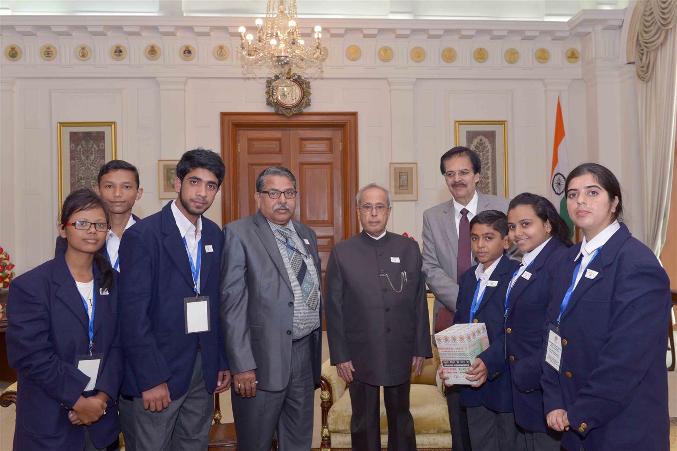 A delegation from the National Foundation for Communal Harmony pinning the flag on the President of India, Shri Pranab Mukherjee at Rashtrapati Bhavan on November 24, 2015 on the occasion of their Flag Week.