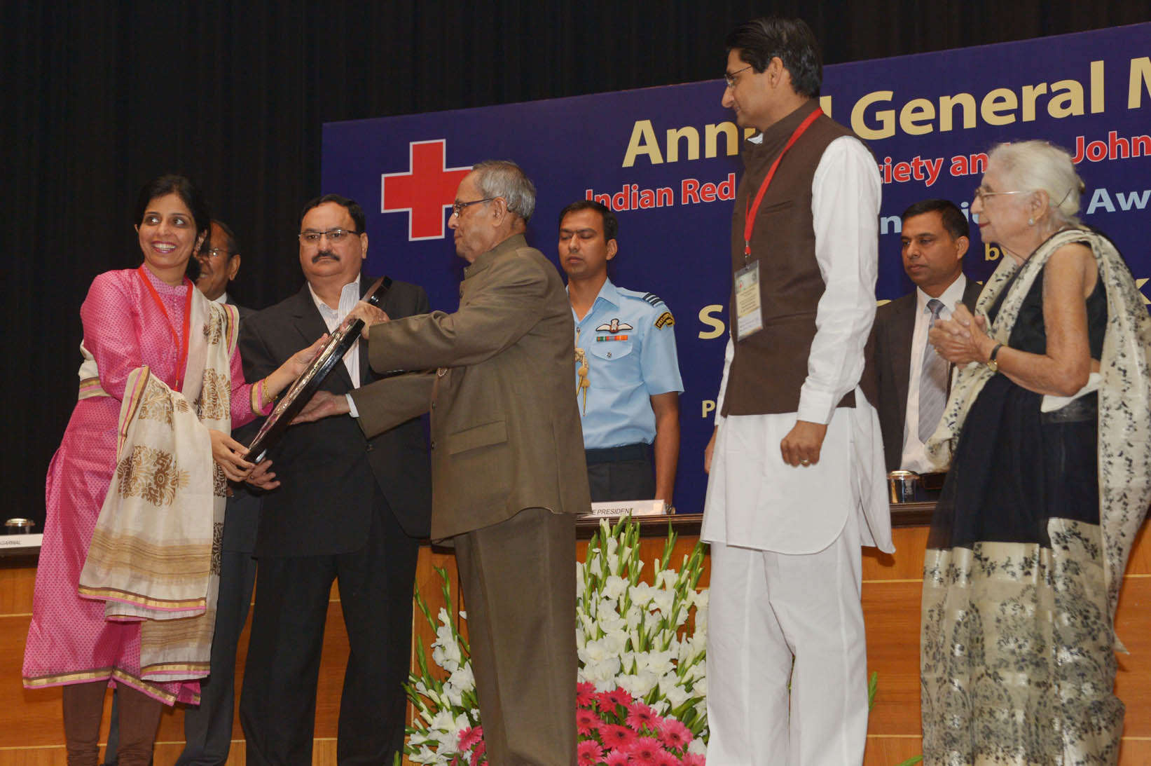 The President of India, Shri Pranab Mukherjee felicitating Red Cross and St. John Volunteer during the Annual General Meeting of the Indian Red Cross Society and St. John Ambulance (India) at Rashtrapati Bhavan Auditorium on November 18, 2014. 