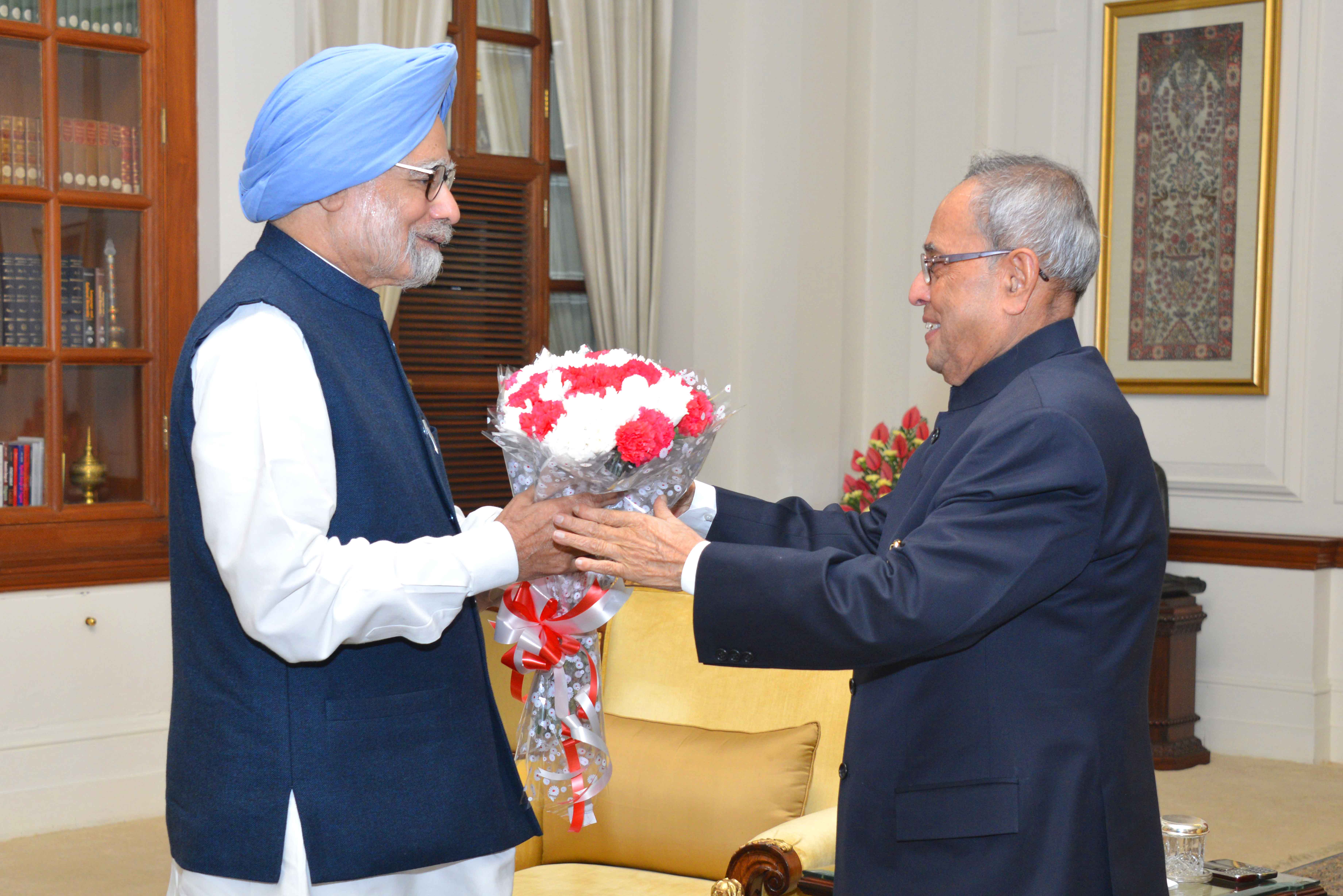 The President of India, Shri Pranab Mukherjee being greeted at Rashtrapati Bhavan on December 11, 2014 by the Former Prime Minister of India, Dr. Manmohan Singh on the occasion of his birthday. 