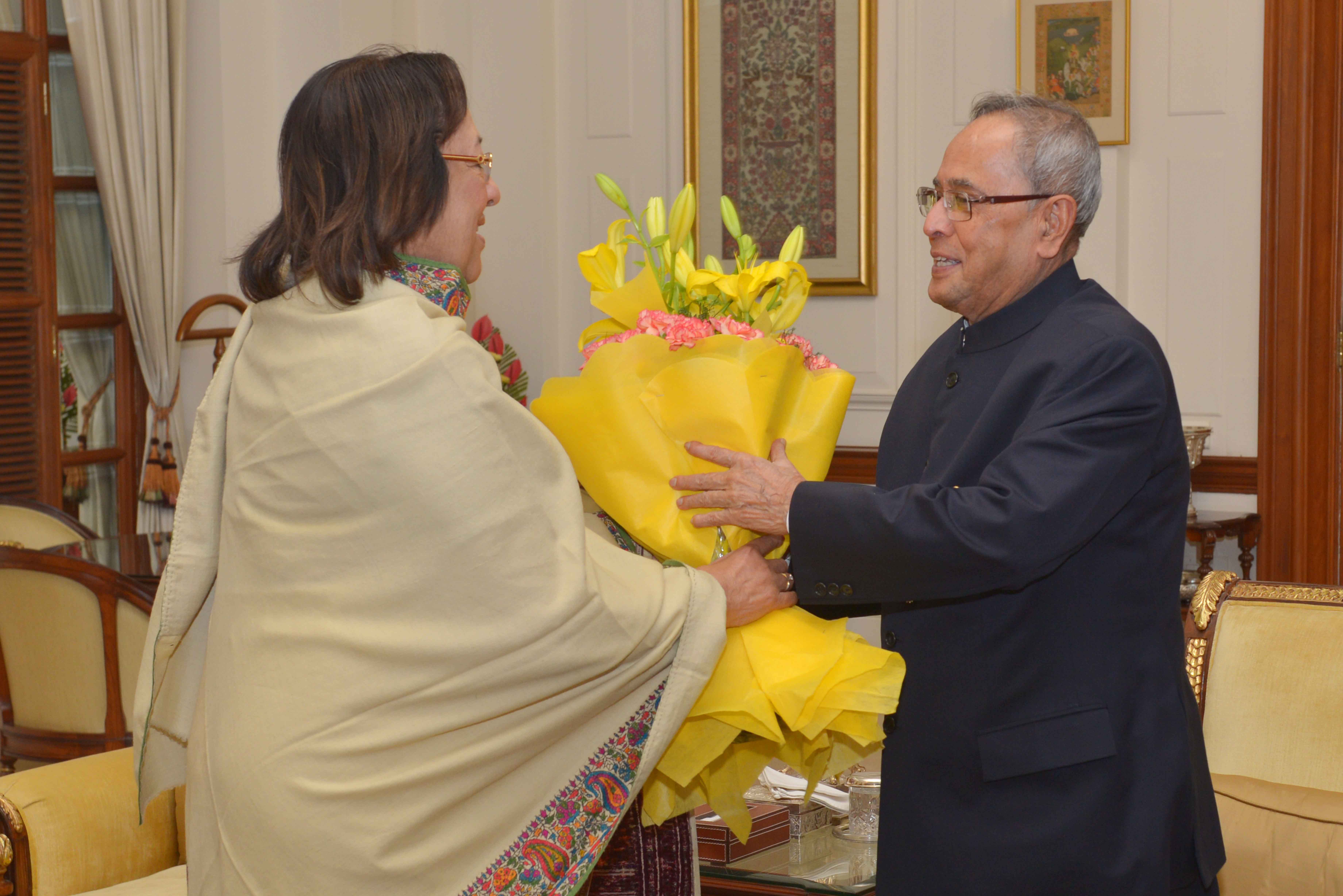 The President of India, Shri Pranab Mukherjee being greeted at Rashtrapati Bhavan on December 11, 2014 by the Union Minister of Minority Affairs, Dr. Najma Heptulla on the occasion of his birthday. 