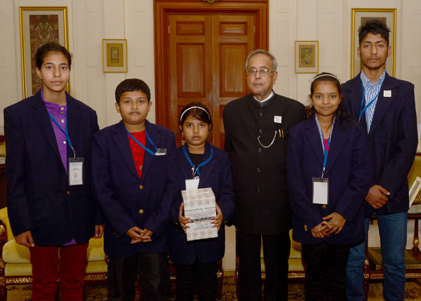 Children’s from National Foundation for Communal Harmony pinning a flag to the President of India, Shri Pranab Mukherjee on the occasion of their Flag Week at Rashtrapati Bhavan in New Delhi on November 25, 2013 when they called-on the President.