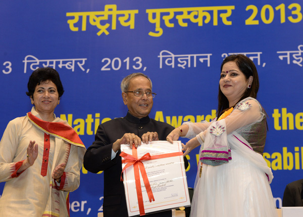 The President of India, Shri Pranab Mukherjee while presenting a National Award for the Empowerment of Persons with Disabilities for the year 2013 on the occasion of International Day of Disabled Persons at Vigyan Bhavan, New Delhi on December 3, 2013.