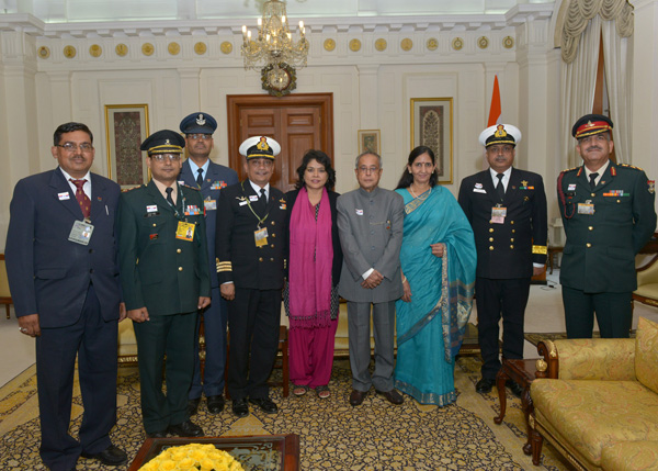 Service Officers and Ladies from the Kendriya Sainik Board, Ministry of Defence pinning a flag to the President of India, Shri Pranab Mukherjee on the occasion of Armed Forces Flag Day at Rashtrapati Bhavan in New Delhi on December 5, 2013 when they call