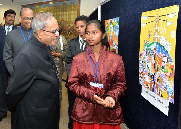 The President of India, Shri Pranab Mukherjee viewing paintings drawn by the children in the painting competition on the occasion of the National Energy Conservation Day.